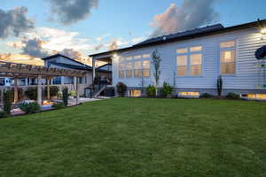 A captivating backyard at dusk, inviting you to envision it as your own tranquil retreat.
