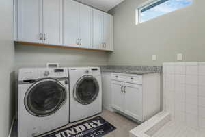 A well-appointed laundry room featuring a convenient dog wash station, designed for both efficiency and pet-friendly care.
