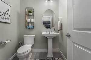 A conveniently located half bathroom just off the basement recreation room, providing easy access and functionality for guests and everyday use.