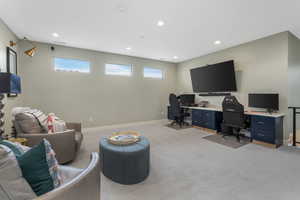This expansive second-level recreation area features a built-in desk, ideal for a home office or study space, offering limitless possibilities within its generous layout.