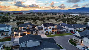 A breathtaking twilight aerial view of this stunning home, with the vast Juniper Canyon Recreation Area stretching out behind it.