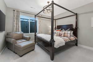 A spacious basement bedroom featuring a private en suite bathroom and walk-in closet.