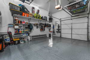This garage is an absolute standout! With its oversized three-car layout and four hydraulic lift storage systems, it offers incredible space and functionality for vehicles, equipment, and everything in between.