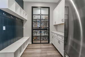 The butler pantry area shares the space of a well-designed entryway from the garage.