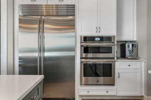 A thoughtfully designed kitchen showcasing high-end stainless steel appliances and custom craftsmanship throughout.