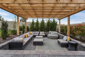 This recessed patio with a pergola offers the perfect spot to unwind and entertain, creating an inviting retreat for any occasion.