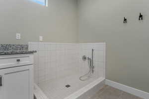 A generously sized laundry room featuring a fantastic dog wash station, combining convenience with thoughtful design.