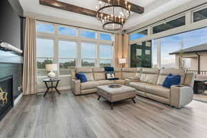 A refined living space featuring a cozy fireplace, sophisticated design elements, and an abundance of natural light streaming through expansive windows.