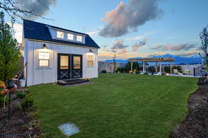 A beautifully illuminated tiny home at sunset, radiating warmth and charm against the evening sky.