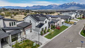 This aerial perspective highlights both the stunning mountain scenery and the charming residential surroundings.