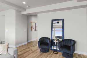 Sitting room with recessed lighting, visible vents, light wood-style floors, and baseboards