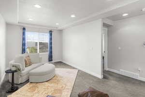 Sitting room with recessed lighting, visible vents, carpet floors, and baseboards
