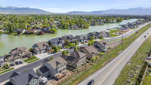 Birds eye view of property with a water and mountain view and a residential view