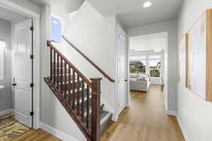 Stairs featuring baseboards, recessed lighting, and wood finished floors