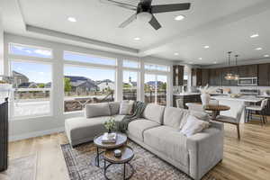 Living room featuring recessed lighting, light wood finished floors, a ceiling fan, and baseboards