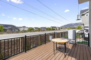 Wooden deck featuring a mountain view and a residential view