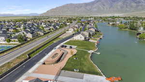 Birds eye view of property with a water and mountain view and a residential view