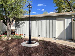 View of outbuilding with fence