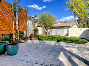 View of patio with a fenced backyard and a gate