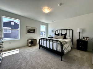 Carpeted bedroom with a textured ceiling and baseboards