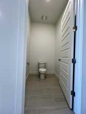 Bathroom with baseboards and toilet