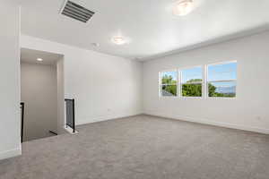 Carpeted empty room featuring baseboards