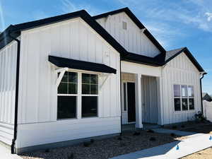 View of front of property featuring covered porch and board and batten siding