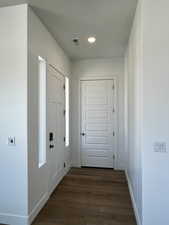 Entryway with dark wood-type flooring, visible vents, recessed lighting, and baseboards