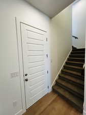 Staircase featuring wood finished floors