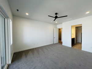 Unfurnished bedroom with visible vents, recessed lighting, and carpet floors