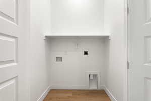 Laundry room featuring electric dryer hookup, washer hookup, and light wood finished floors