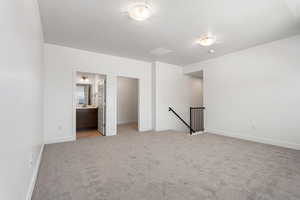 Unfurnished room with light carpet and baseboards