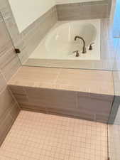 Bathroom featuring a bath and tile patterned floors