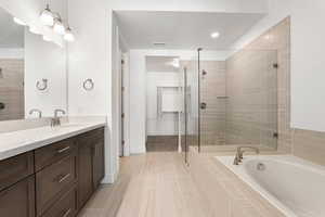 Bathroom with vanity, a stall shower, a bath, and tile patterned floors