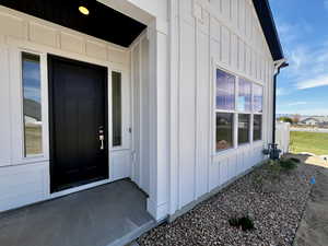 Doorway to property with board and batten siding