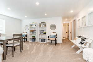 Interior space with recessed lighting, light carpet, and baseboards