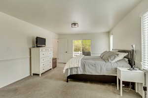 Bedroom featuring light carpet