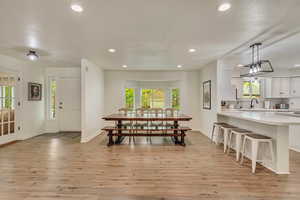 Dining room with recessed lighting, light wood-style flooring, and plenty of natural light