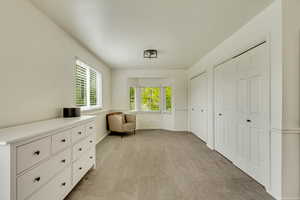 Living area featuring baseboards and light colored carpet