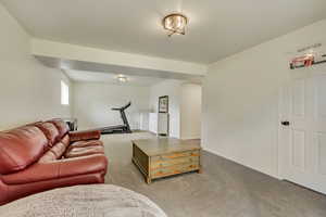 Carpeted living room featuring baseboards
