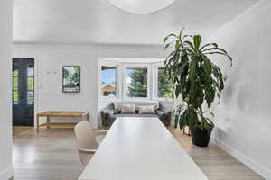 Office space featuring light wood-type flooring, crown molding, and baseboards