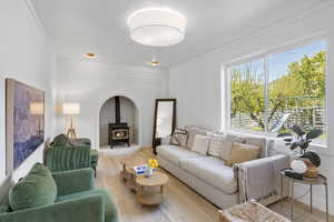 Living room featuring a wood stove and wood finished floors