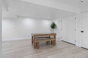 Dining area featuring light wood-type flooring and baseboards