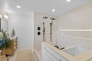 Full bath with recessed lighting, a walk in shower, tile patterned floors, and vanity