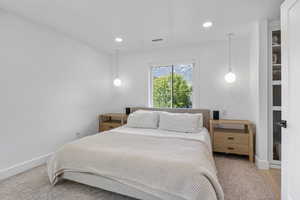 Bedroom with recessed lighting, visible vents, light wood-style floors, and baseboards