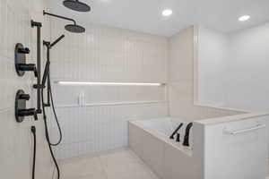 Full bathroom featuring recessed lighting, tile walls, a garden tub, walk in shower, and tile patterned flooring