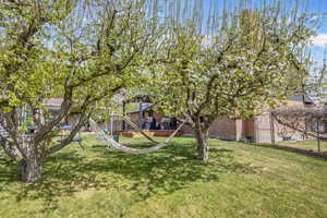 View of yard featuring a playground and fence