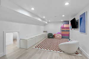 Interior space featuring baseboards, recessed lighting, and wood finished floors