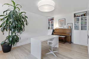 Office space with light wood-style flooring