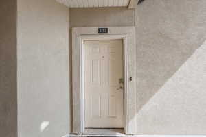 Property entrance with stucco siding